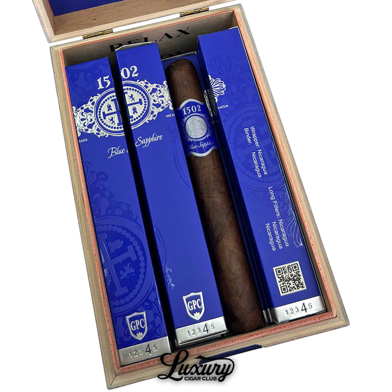 Close-up of 1502 Blue Sapphire Toro Gordo cigar and packaging showcasing detailed blue label at Luxury Cigar Club.