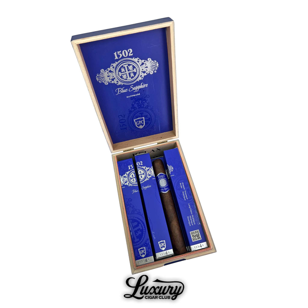 Open box of 1502 Blue Sapphire Toro Gordo cigars with blue packaging and wooden humidor box at Luxury Cigar Club.