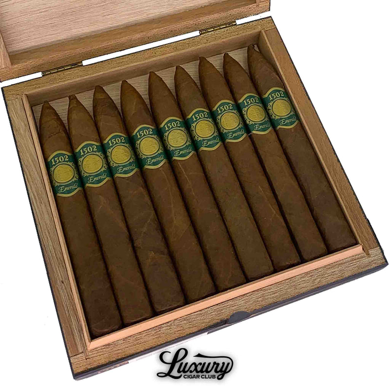 Close-up view of 1502 Emerald cigars neatly arranged in an open box, featuring pointed tips and green gold bands, premium handmade Nicaraguan cigars from Luxury Cigar Club.