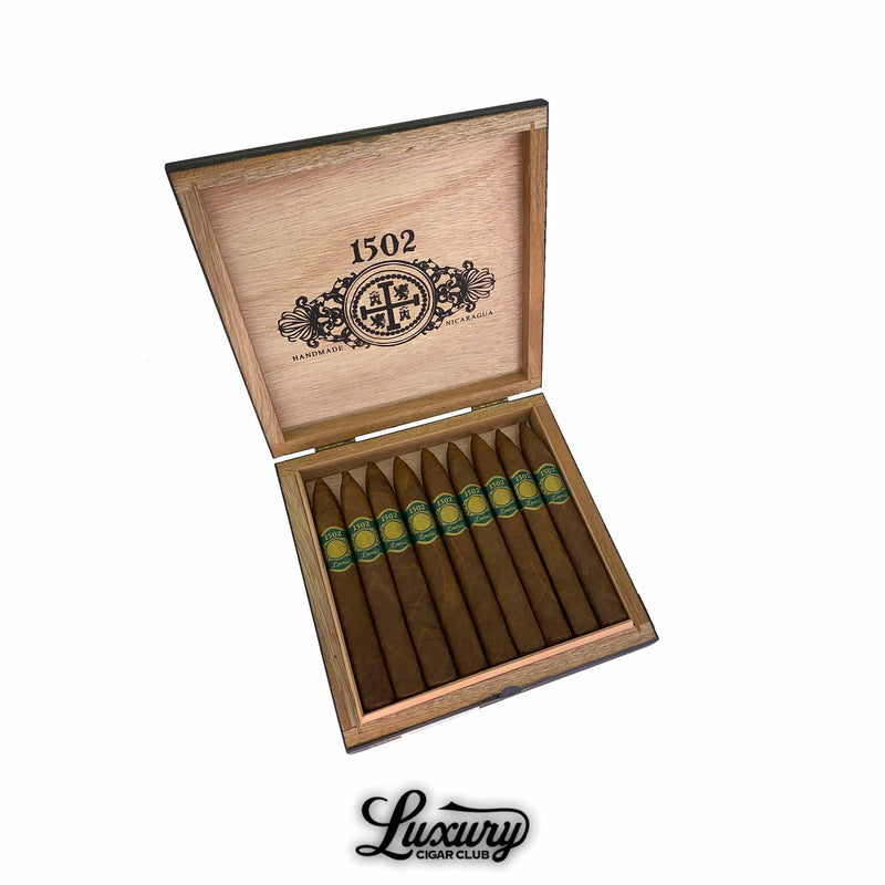 Open box of 1502 Emerald cigars with pointed tips and green bands, showcasing handmade Nicaraguan premium cigars at Luxury Cigar Club.