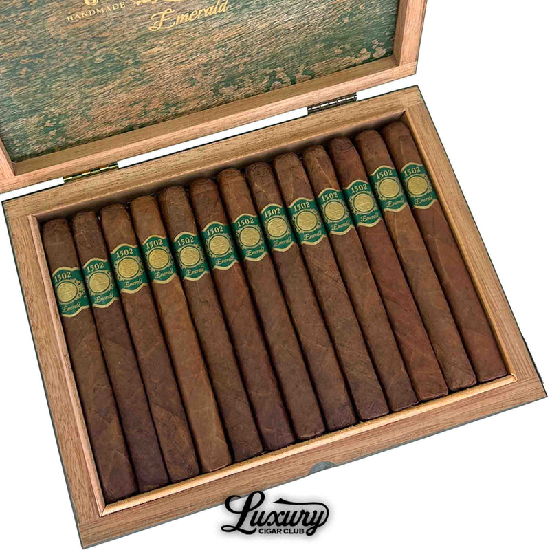 Close-up of 1502 Emerald Corona cigars inside box, highlighting natural brown wrappers with green bands, Luxury Cigar Club.