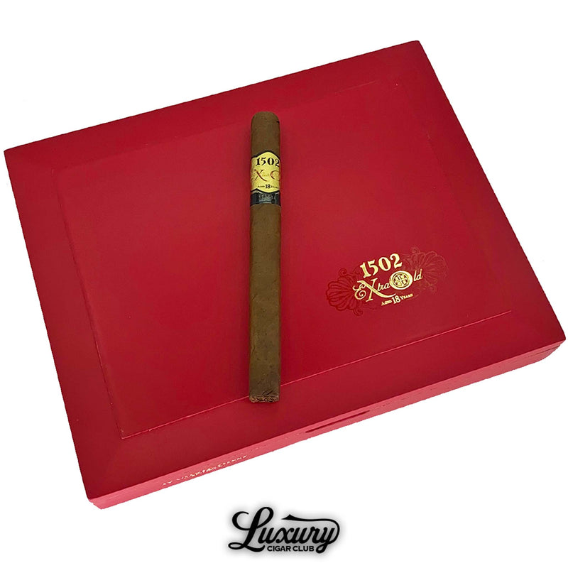 Close-up image of a single 1502 XO cigar resting on a bold red 1502 XO box with gold logo, highlighting the aged premium blend offered by Luxury Cigar Club.