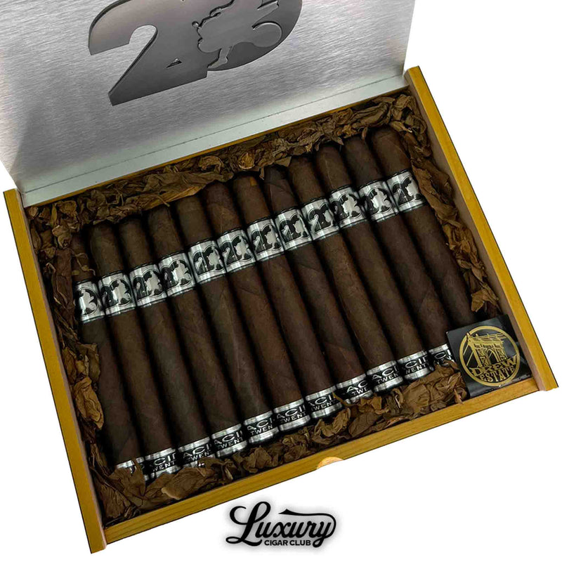 Close-up of open ACID 20 Maduro Toro Cigars box with neatly arranged cigars wrapped in dark leaf and adorned with silver and black anniversary bands. Luxury Cigar Club logo