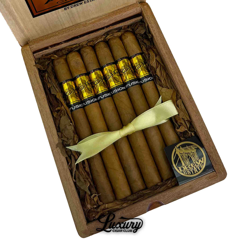 Close-up of ACID Gold Cold Fusion cigars with golden bands inside wooden box, featuring Luxury Cigar Club logo – Drew Estate premium infused cigars