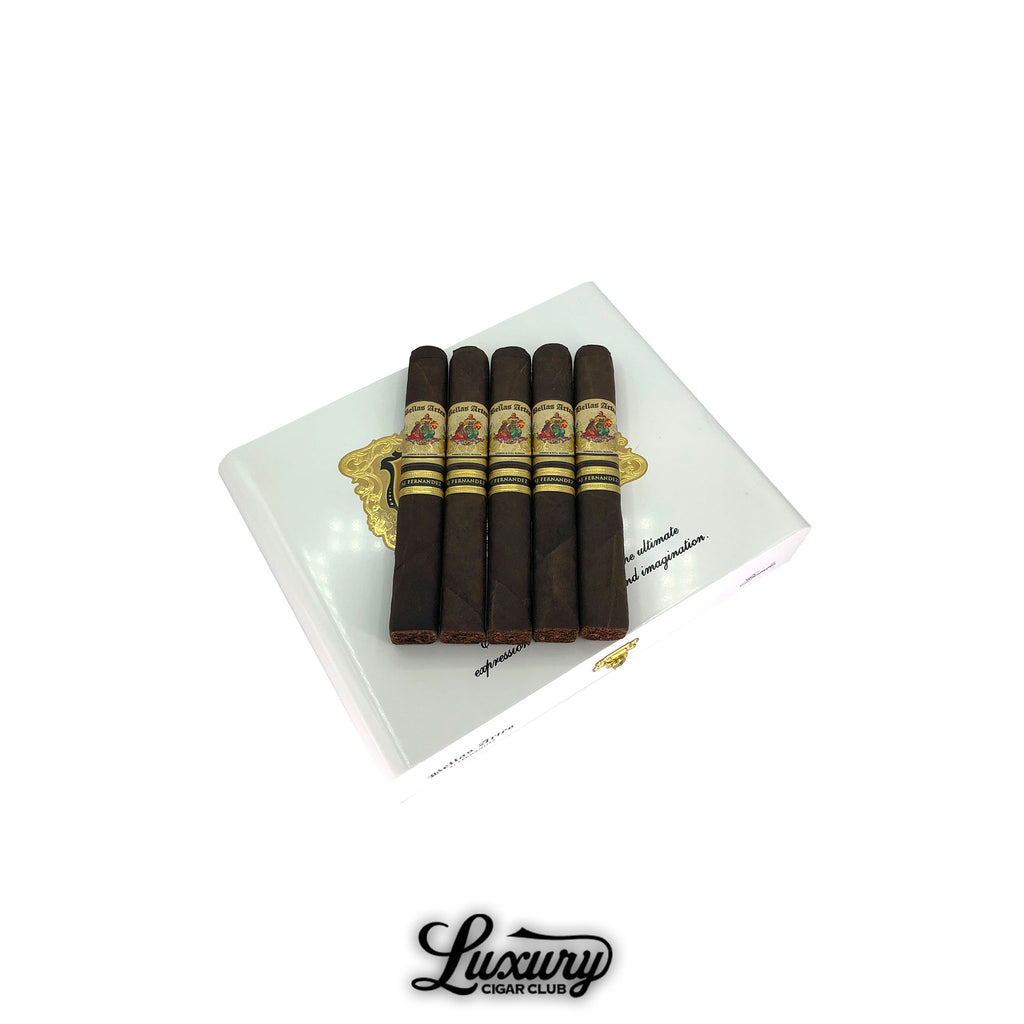 AJ Fernandez Bellas Artes Maduro Gordo cigars resting on a white and gold embossed box, showcasing their rich dark wrappers and elegant band design, presented by Luxury Cigar Club.