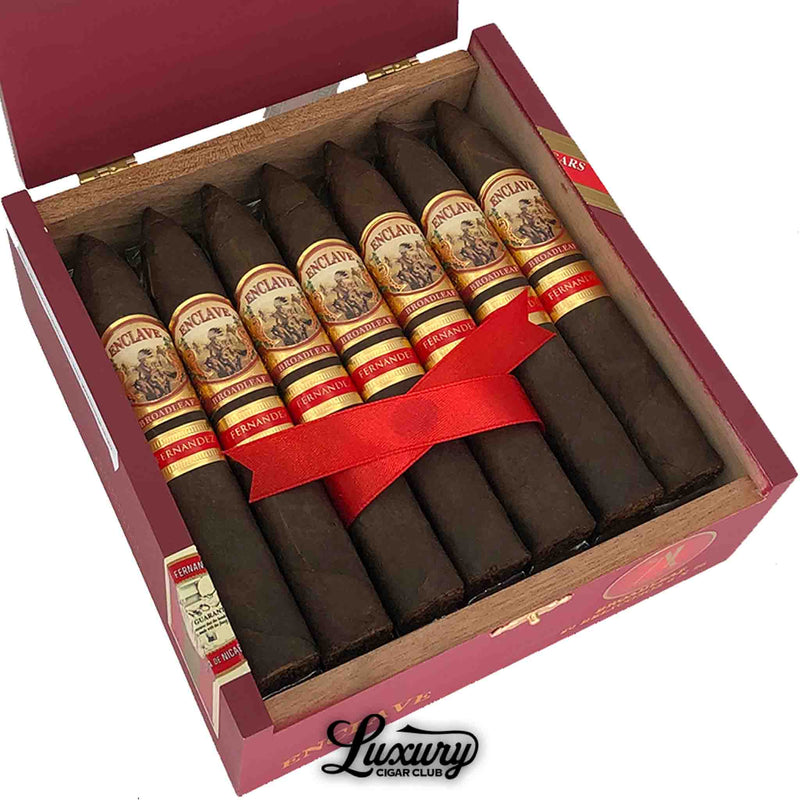 Close up of Enclave AJ Fernandez Broadleaf Belicoso cigars inside the box, showing dark wrapper and detailed band artwork, photographed for Luxury Cigar Club