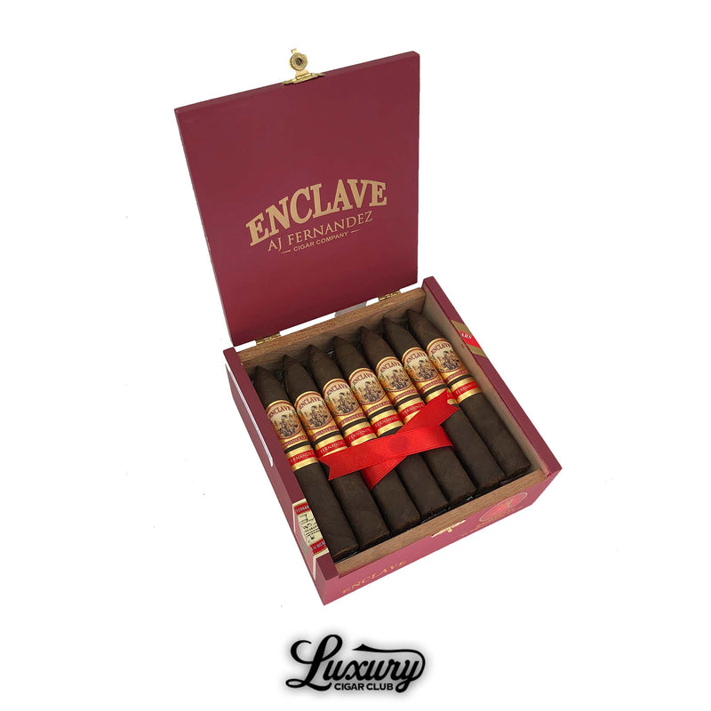 Open red Enclave AJ Fernandez cigar box filled with torpedo shaped Broadleaf Belicoso cigars with gold and red bands, presented on white background, Luxury Cigar Club branding