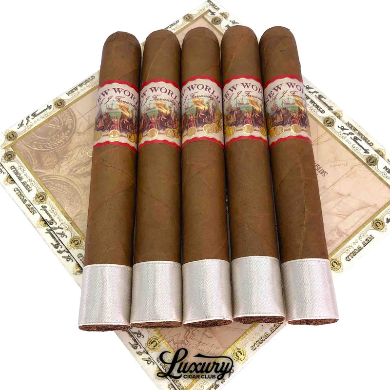 AJ Fernandez New World Connecticut Toro cigars arranged on the matching box lid, showing smooth Connecticut wrappers and gold-accented bands, presented by Luxury Cigar Club.