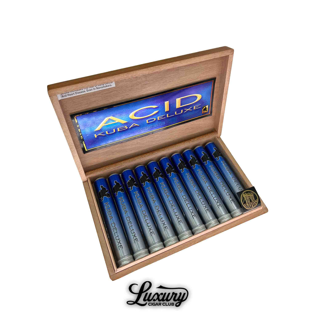 Open box of Acid Kuba Deluxe Tubo cigars by Drew Estate, featuring individually tubed cigars in metallic blue and silver tubes with black silhouette artwork. The inside lid displays the vibrant “Acid Kuba Deluxe” branding. Luxury Cigar Club logo appears at the bottom.