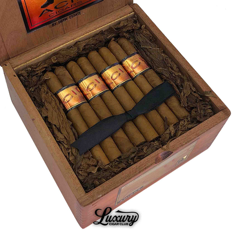 Close-up of open box of Acid Subcultures Amigos cigars by Drew Estate, showing golden bands and packed leaves from Luxury Cigar Club.