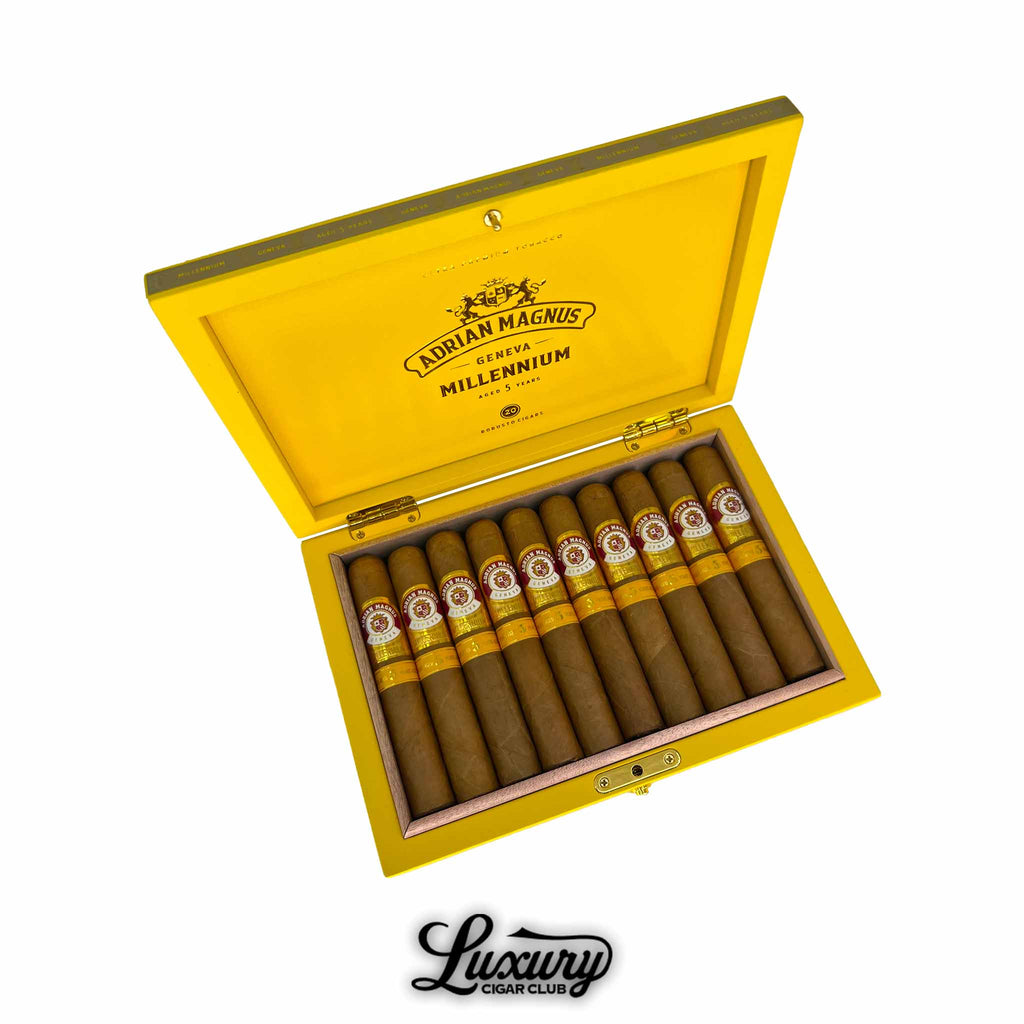 Open yellow box of Adrian Magnus Millennium Robusto cigars aged 5 years, neatly arranged with golden bands, available at Luxury Cigar Club.
