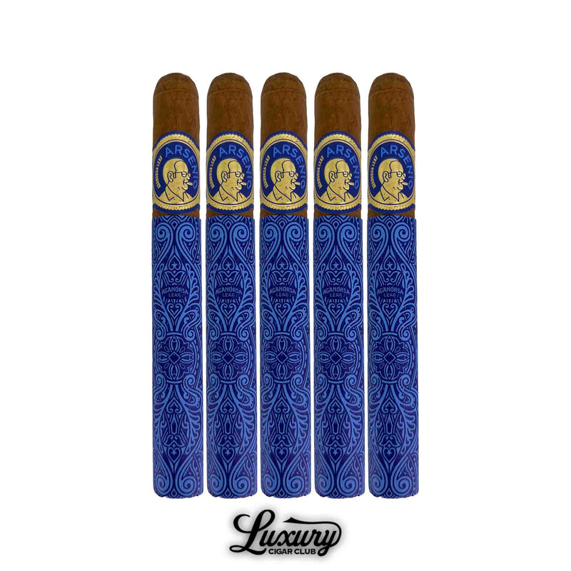 Five Aganorsa Leaf Arsenio Corona cigars displayed in a tight 5-pack, adorned in detailed blue and gold wrapping with polished brown caps. A sophisticated presentation honoring Arsenio Ramos’ legacy. Luxury Cigar Club.