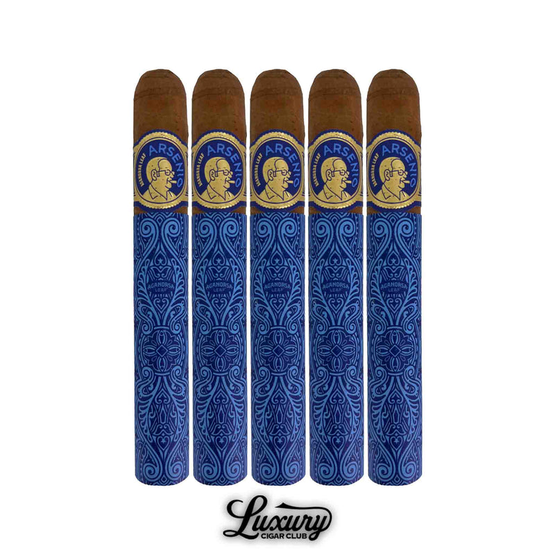 Five Aganorsa Leaf Arsenio Toro cigars lined up side by side, each wrapped in elegant blue and gold decorative paper featuring intricate patterns and the Arsenio logo. The cigars display rich brown wrappers and refined presentation. Luxury Cigar Club.