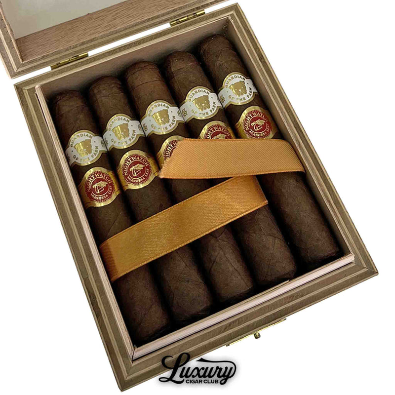 Close-up of Aganorsa Leaf Guardian of the Farm Night Watch Rambo cigars inside open box with gold ribbon and detailed band, premium cigars at Luxury Cigar Club.