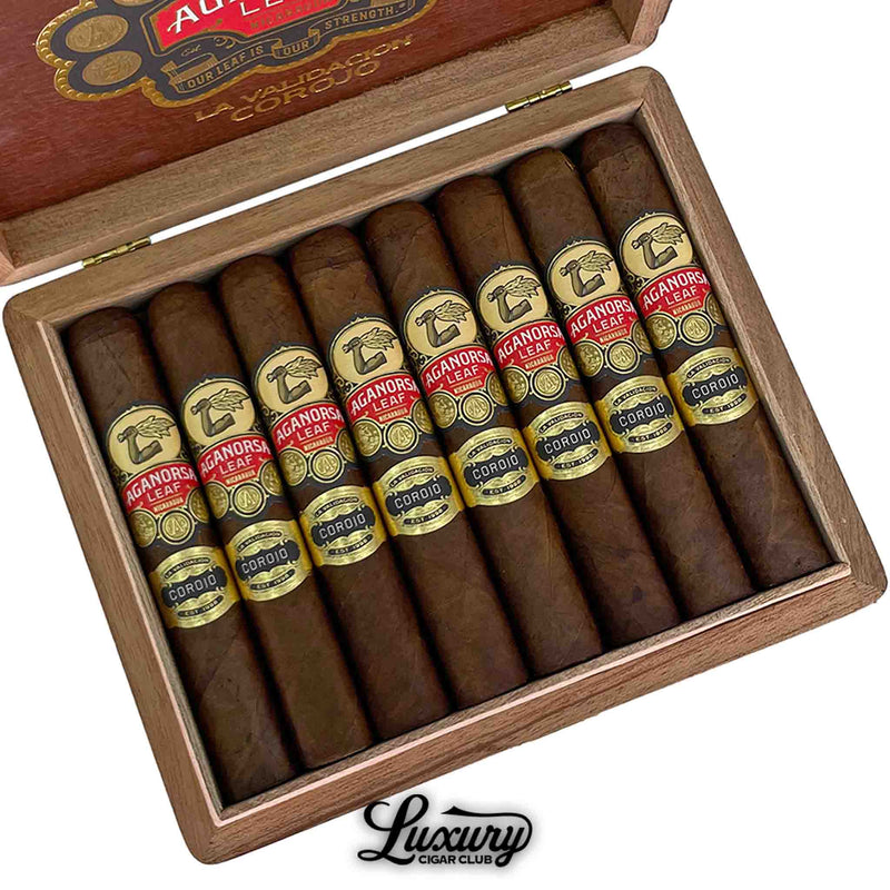 Close-up image of Aganorsa Leaf La Validacion Corojo Gran Robusto cigars in an open wooden box from Luxury Cigar Club, showcasing premium Nicaraguan handmade cigars with gold and red bands for online purchase.
