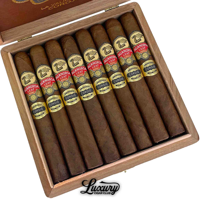 Close-up of Aganorsa Leaf La Validacion Corojo Toro cigars inside a wooden box, showcasing detailed cigar bands with gold and red accents, available online at Luxury Cigar Club for premium cigar aficionados.