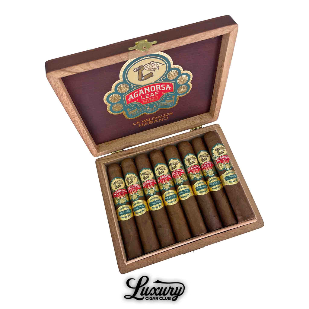Aganorsa Leaf La Validación Habano Gran Robusto cigars neatly packed in an open wooden box with red and gold branding, displayed by Luxury Cigar Club.