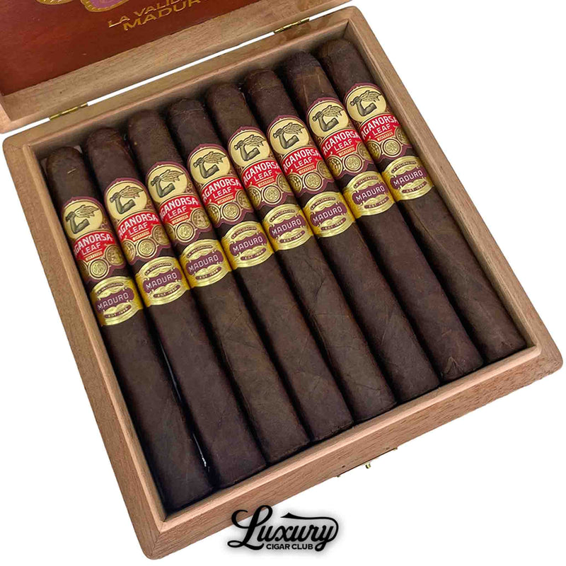Close-up image of Aganorsa Leaf La Validacion Maduro Toro cigars in an open box, showcasing rich maduro wrappers and detailed red and gold cigar bands, from Luxury Cigar Club.