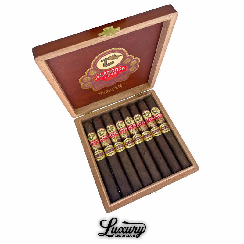 Open box of Aganorsa Leaf La Validacion Maduro Toro cigars with dark maduro wrappers and red-gold bands, premium handmade cigars displayed by Luxury Cigar Club.