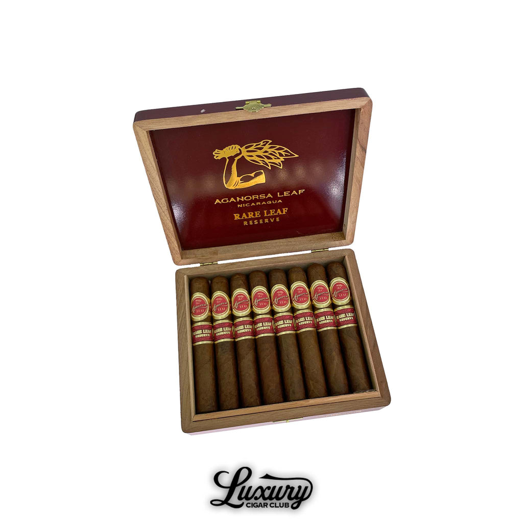 Aganorsa Leaf Rare Leaf Reserve Robusto cigars displayed in an open wooden box with red and gold interior, available at Luxury Cigar Club.