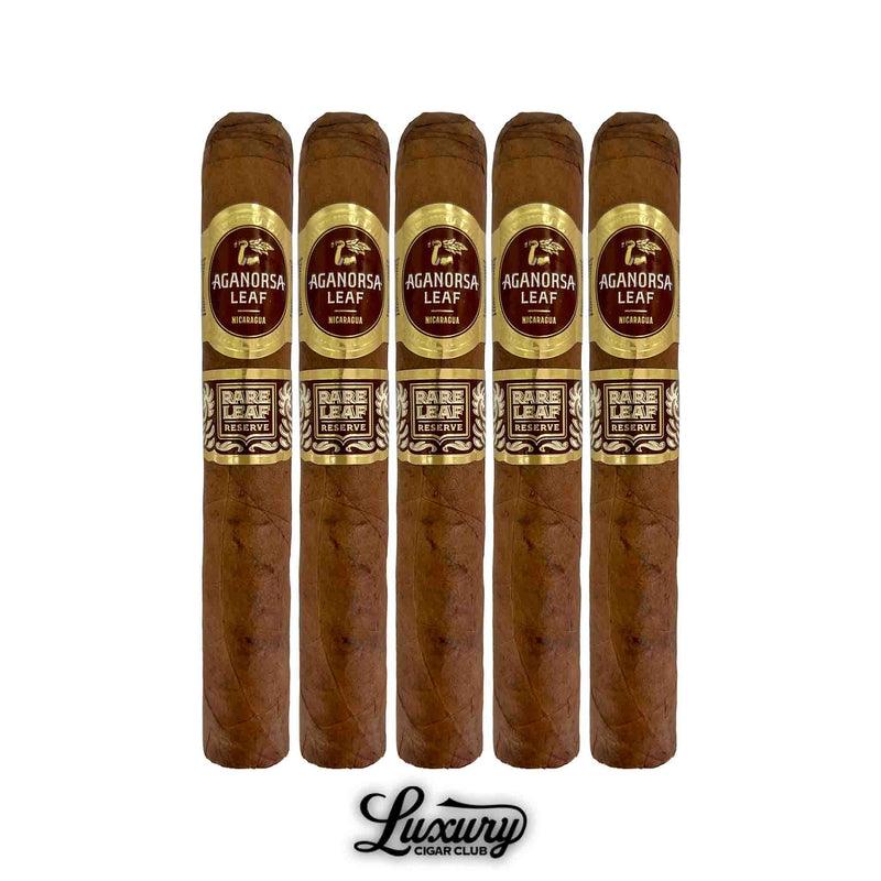 Five Aganorsa Leaf Rare Leaf Reserve Corojo Toro cigars arranged upright, featuring smooth brown wrappers and gold-accented maroon bands marked “Rare Leaf Reserve.” Premium Nicaraguan cigars from Luxury Cigar Club.