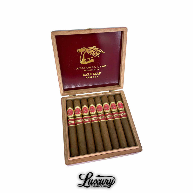 Aganorsa Leaf Rare Leaf Reserve Toro cigars neatly arranged in an open red and gold branded wooden box, available at Luxury Cigar Club.
