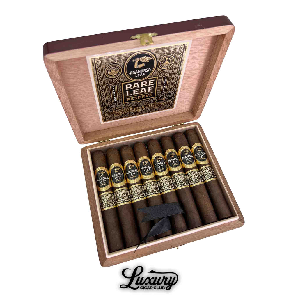 Open box of Aganorsa Leaf Rare Leaf Reserve Maduro Robusto cigars displayed inside a cedar box with black and gold bands, Luxury Cigar Club.
