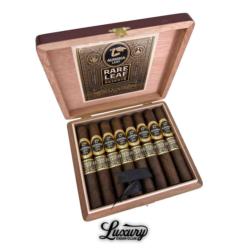 Open box of Aganorsa Leaf Rare Leaf Reserve Maduro Robusto cigars displayed inside a cedar box with black and gold bands, Luxury Cigar Club.