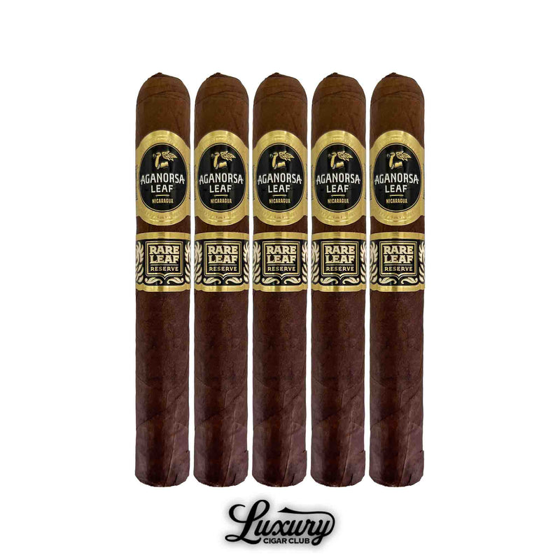 Five Aganorsa Leaf Rare Leaf Reserve Maduro Toro cigars displayed upright, each featuring dark brown wrappers and gold-accented black bands marked “Rare Leaf Reserve.” Luxury Cigar Club.