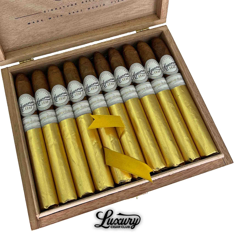 Open box of Aganorsa Leaf Signature Selection Belicoso cigars wrapped in gold foil with white bands, premium Nicaraguan cigars available at Luxury Cigar Club.