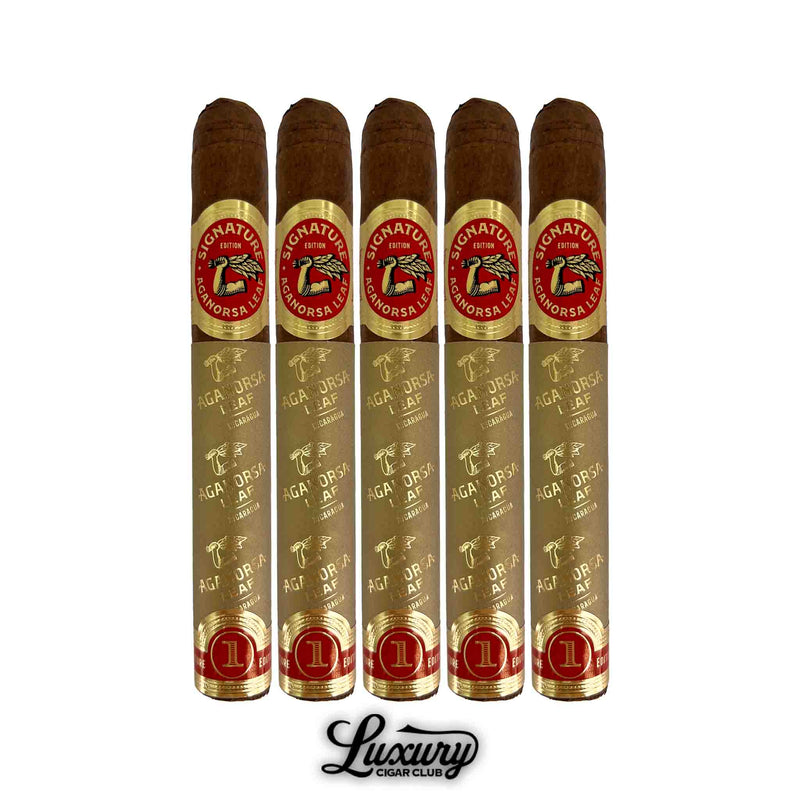 Five Aganorsa Leaf Signature Selection Toro cigars shown in gold foil wrapping, each adorned with the red and gold “Signature Edition” label. Premium presentation for Nicaraguan cigars by Luxury Cigar Club.