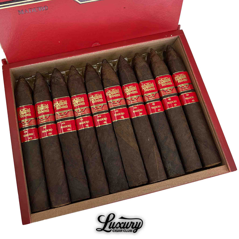 Close-up of Aging Room Nicaraguan Quattro Maduro Maestro cigars box showing dark, perfectly rolled torpedo cigars with red bands, Luxury Cigar Club exclusive.