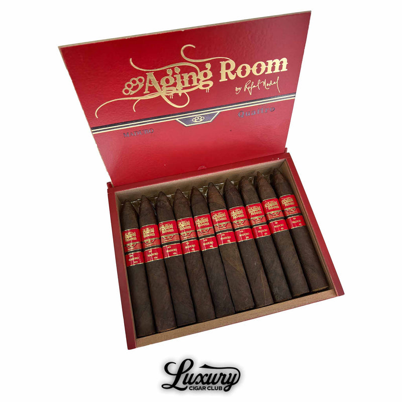 Open box of Aging Room Nicaraguan Quattro Maduro Maestro cigars featuring rich dark wrappers, premium torpedo cigars available online at Luxury Cigar Club.