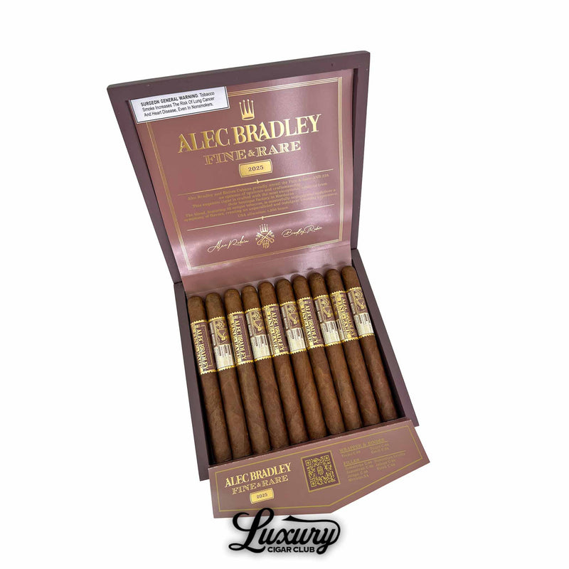 Open box of Noble Cigars Act One Toro from Luxury Cigar Club, showing ten brown toro cigars in a black velvet lined tray with black and yellow bands under a glossy black and gold lid.