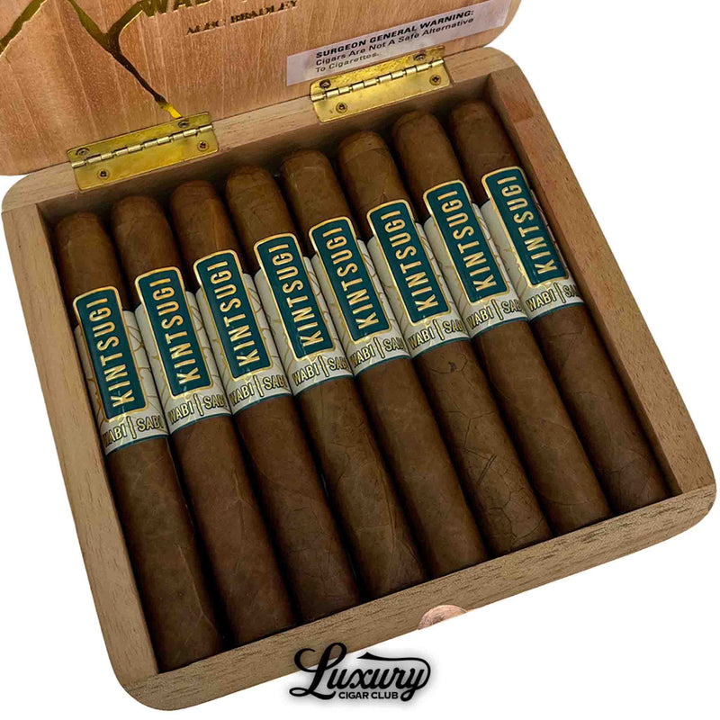 Close-up view of Alec Bradley Kintsugi Wabi Sabi Limited Edition Toro cigars inside an open wooden box, showing detailed cigar bands, with the Luxury Cigar Club logo.