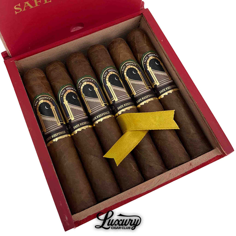 Close-up of Alec Bradley Safe Keepings Robusto cigars showcasing detailed cigar bands and rich wrapper color, presented with a gold ribbon inside a red box — premium cigars from Luxury Cigar Club.