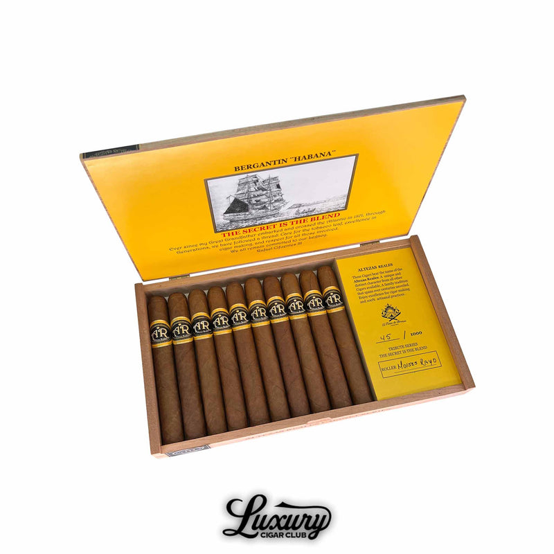 Open box of Altezas Reales 1871 Corona cigars with yellow interior, featuring black and gold cigar bands and tribute series insert, from Luxury Cigar Club.