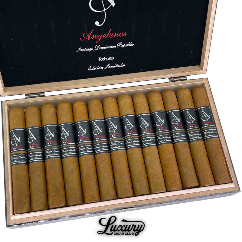  Close-up of Angelenos Limited Edition Robusto cigars highlighting elegant black cigar bands with silver "A" logo and red script, nestled inside a wooden box from Luxury Cigar Club.