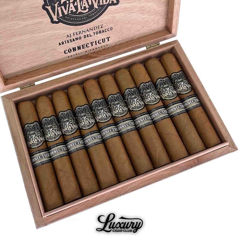 Close-up of a box of Artesano Del Tabacco Viva La Vida Connecticut Robusto cigars, featuring 10 cigars with golden Connecticut wrappers and black bands marked “Viva La Vida” and “Connecticut.” The inside lid is etched with AJ Fernandez branding and product origin. Luxury Cigar Club logo appears at the bottom.
