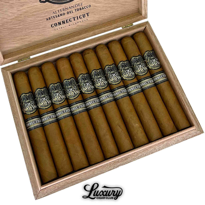Close-up of Artesano Del Tabacco Viva La Vida Connecticut Toro cigars in an open box, highlighting the golden Connecticut wrappers and bold black-and-silver bands with "Viva La Vida" and "Connecticut" labels. The Luxury Cigar Club logo is positioned at the bottom of the image.