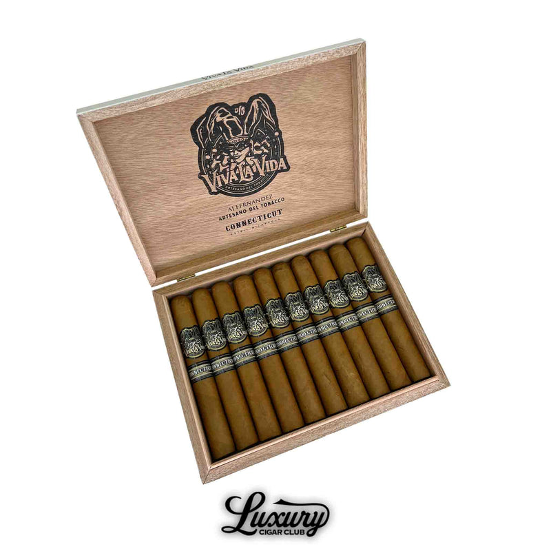 Box of Artesano Del Tabacco Viva La Vida Connecticut Toro cigars displayed open, showcasing ten cigars with light brown Connecticut wrappers and ornate black-and-silver bands. The inside lid is branded with the Viva La Vida logo, and the Luxury Cigar Club logo is visible below the box.