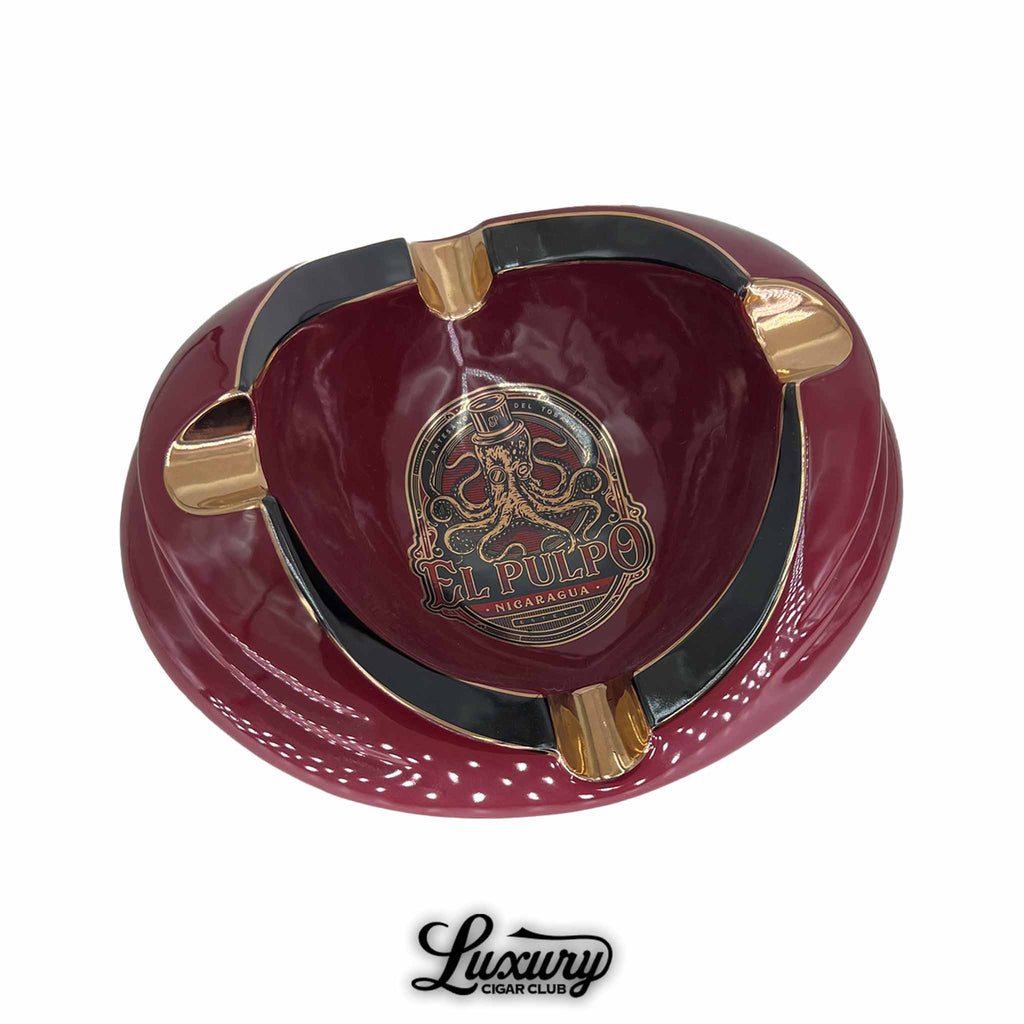 Round maroon ceramic El Pulpo ashtray with gold-accented cigar rests and a black inner rim, featuring the El Pulpo Nicaragua logo with an octopus and top hat design at the center.
