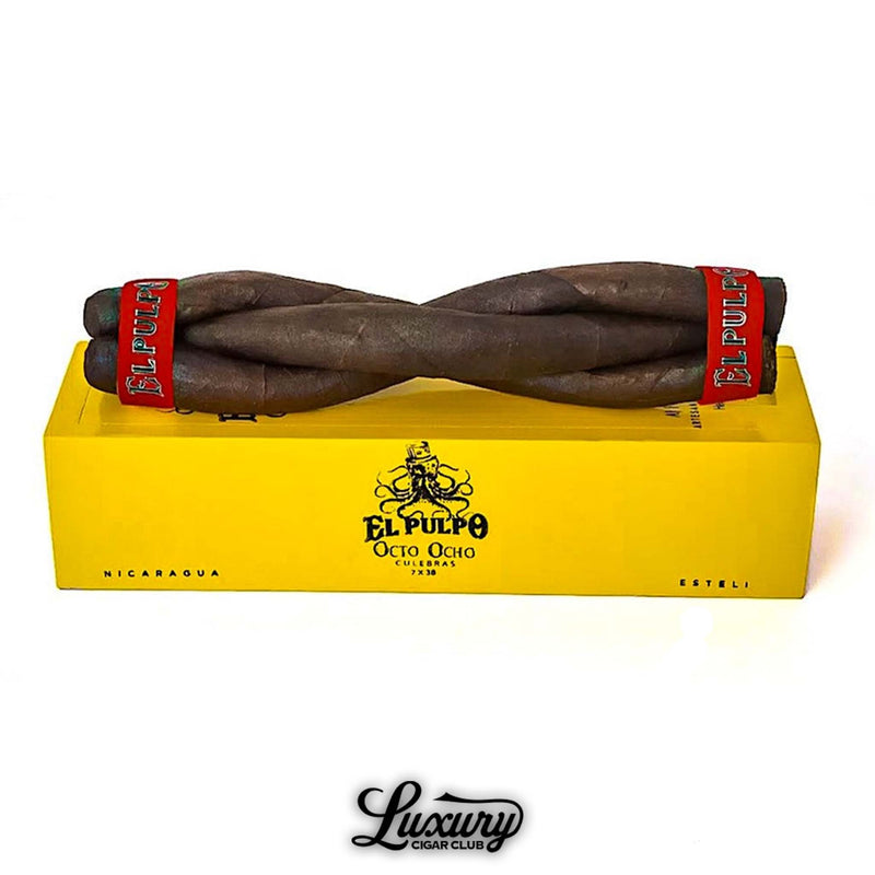 Close-up of Artesano Del Tobacco El Pulpo Octo Ocho Culebra cigars, twisted in a braided shape with red bands, resting on a bright yellow box featuring octopus artwork and branding.