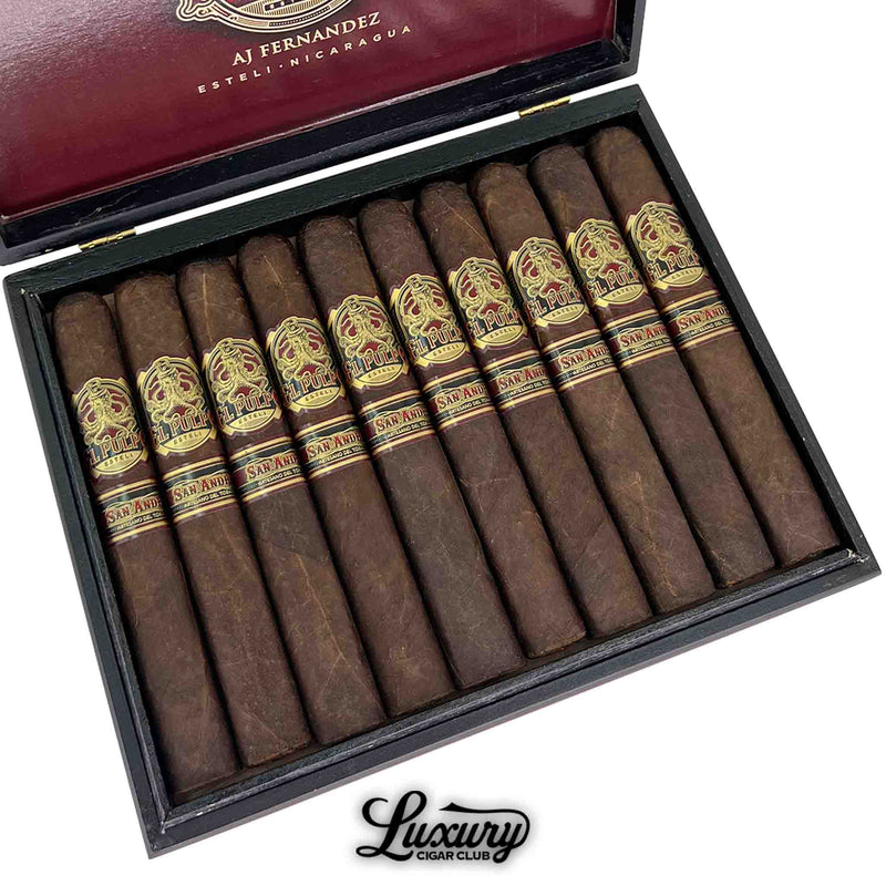 Close-up of a box of Artesano Del Tobacco El Pulpo Toro Grande cigars, showcasing 10 dark San Andrés-wrapped cigars with gold and red octopus-themed bands. The band reads "El Pulpo" and "San Andres." Interior box lid features the AJ Fernandez Estelí, Nicaragua insignia. Luxury Cigar Club logo at the bottom.
