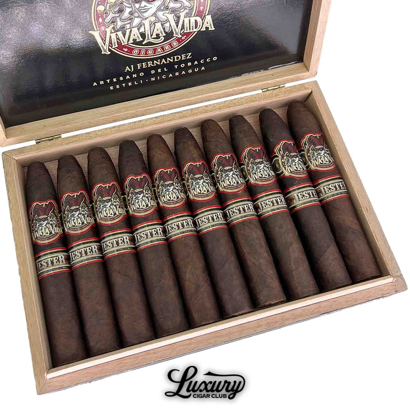 Close-up view of Artesano Del Tobacco Viva La Vida 5th Anniversary Jester Flat Round Belicoso cigars, showcasing detailed jester-themed bands and expertly rolled dark wrappers in a cedar box by AJ Fernandez in Estelí, Nicaragua.