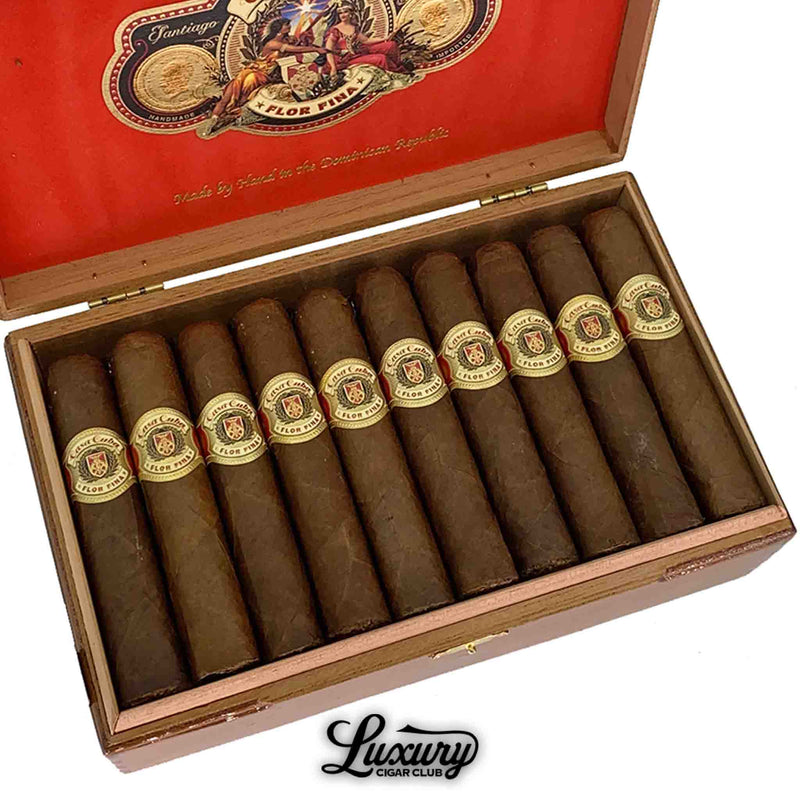 Close-up of Arturo Fuente Casa Cuba Doble Cuatro cigars in an open box, showcasing detailed golden cigar bands and red velvet box lining with the Casa Cuba logo.