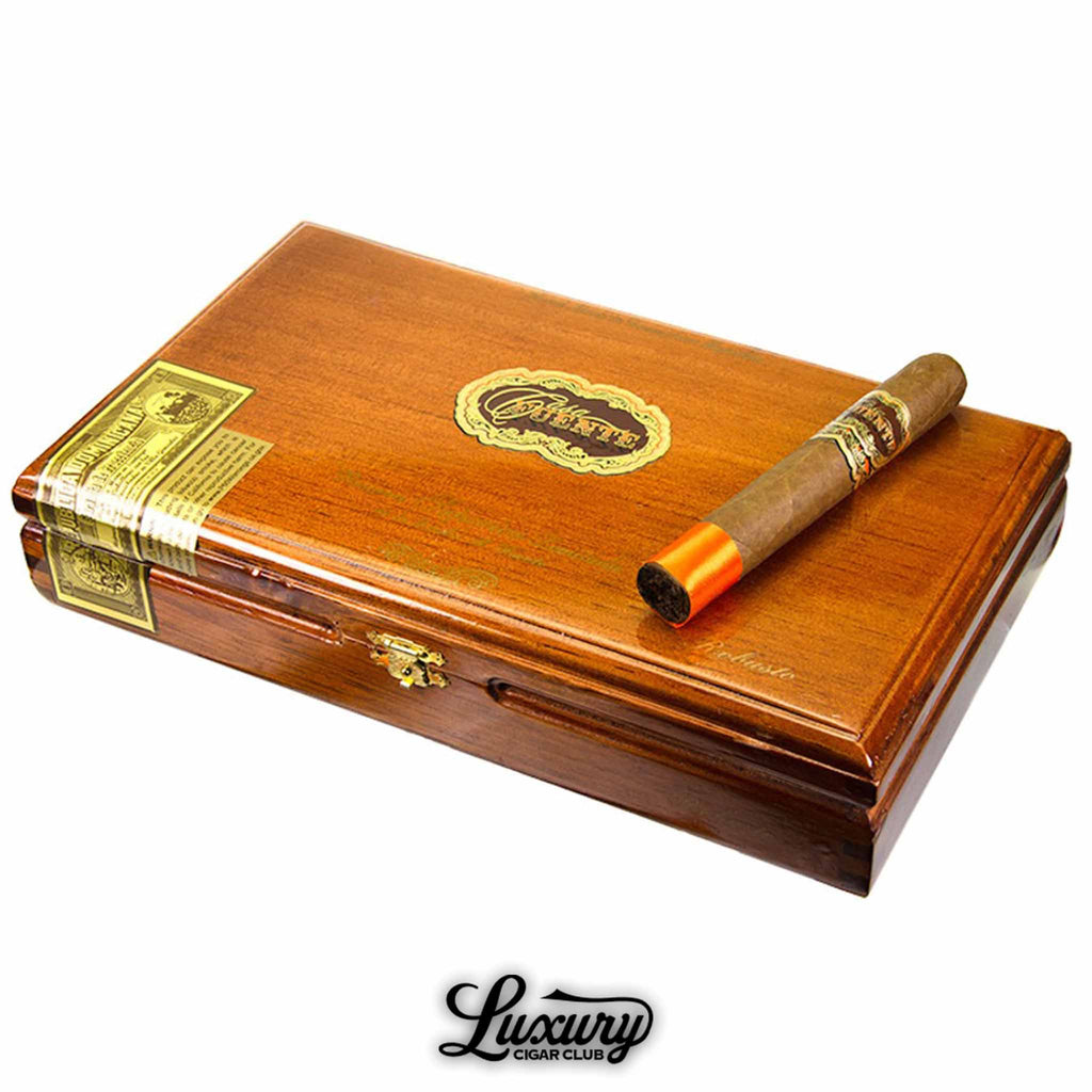Arturo Fuente Casa Fuente Limited Edition Robusto cigar resting on a closed cedar box with gold accents, available at Luxury Cigar Club.