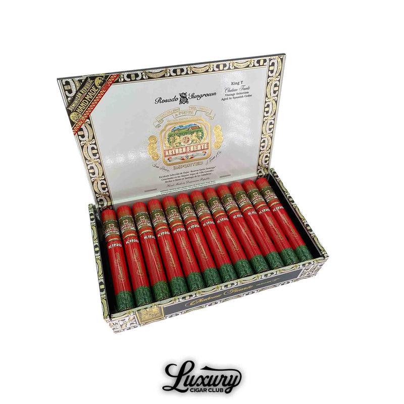 Open box of Arturo Fuente Chateau Fuente King T Rosado Sun Grown Tubo cigars, each encased in red and green aluminum tubes, displayed in branded packaging.