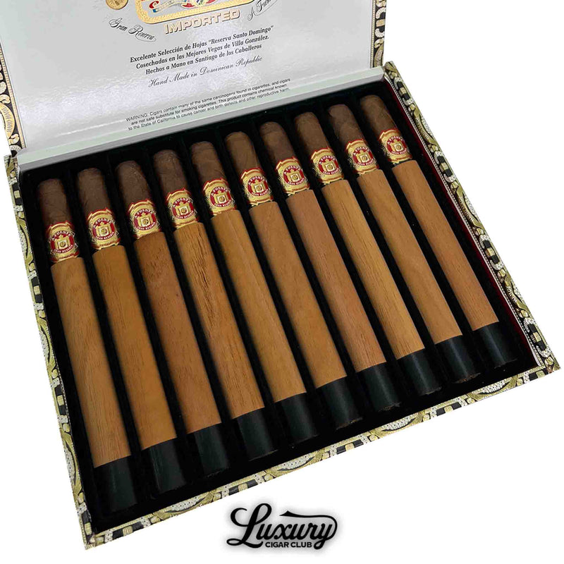 Close-up of Arturo Fuente Chateau Fuente Royal Salute Sun Grown cigars in cedar sleeves with red and gold bands, neatly arranged in a premium open box.