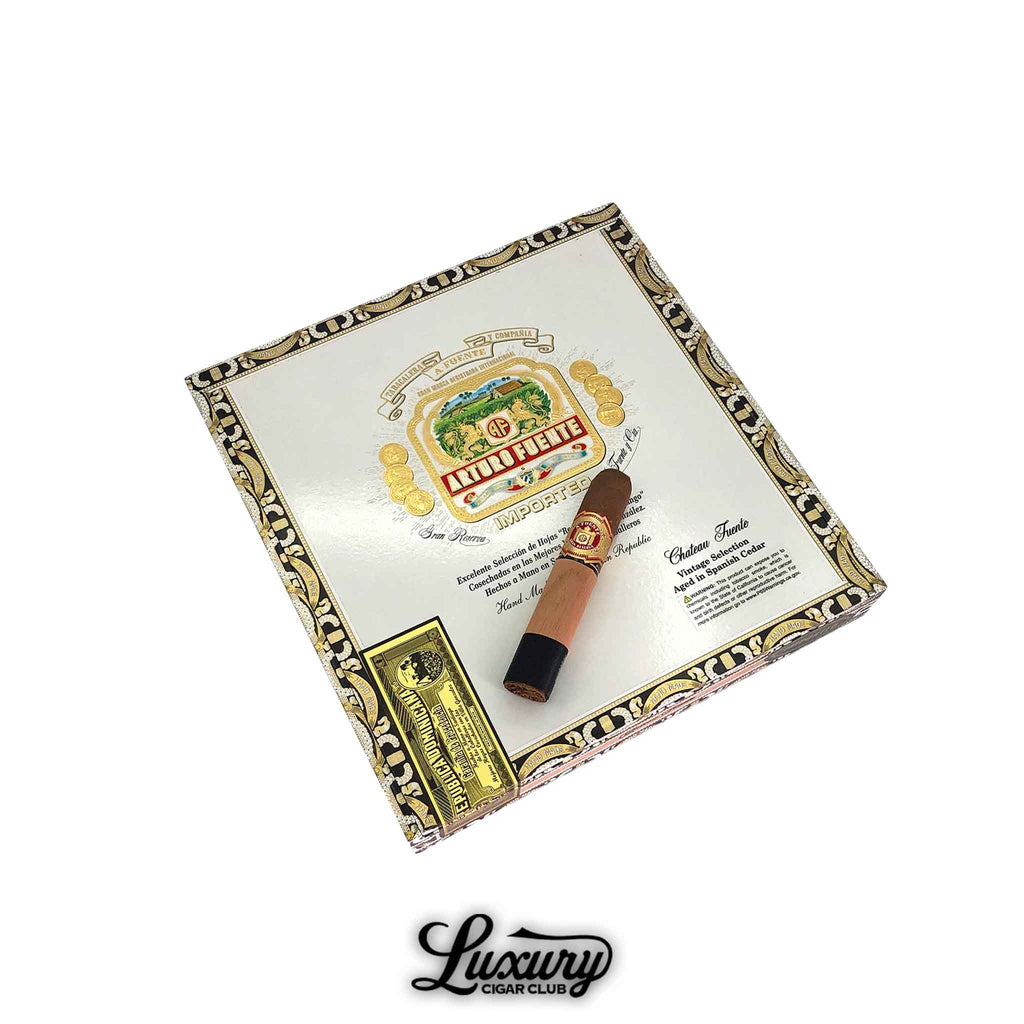 Arturo Fuente Chateau Fuente Sun Grown cigar placed on top of its decorative cigar box, available at Luxury Cigar Club.